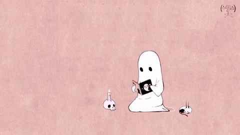 A gif of a little ghost reading a book next to a candle light